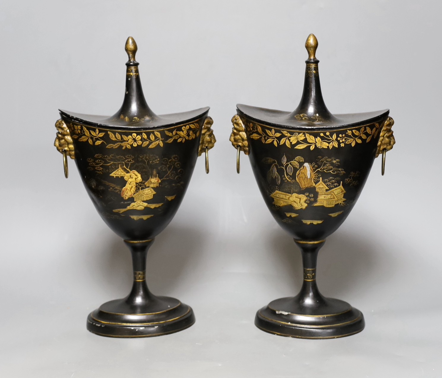 A pair of Japanned toleware urns and covers, 33cm tall